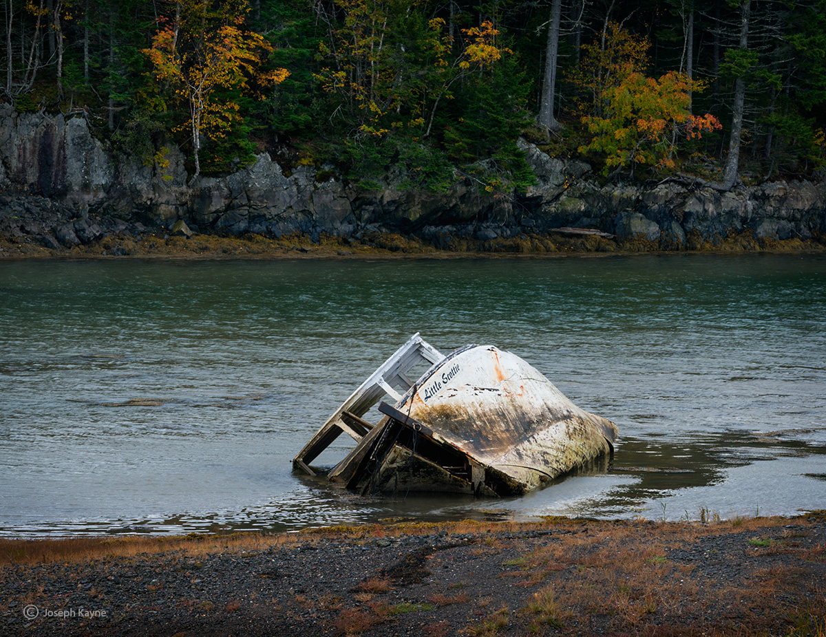 An Abandoned Boat Lies In A New Brunswick Cove
